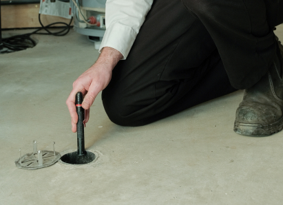Oosterveld service personnel inserting a diagnostic tool into a floor drain for a residential drain and sewer service check. Oosterveld service personnel inserting a diagnostic tool into a floor drain for a residential drain and sewer service check.